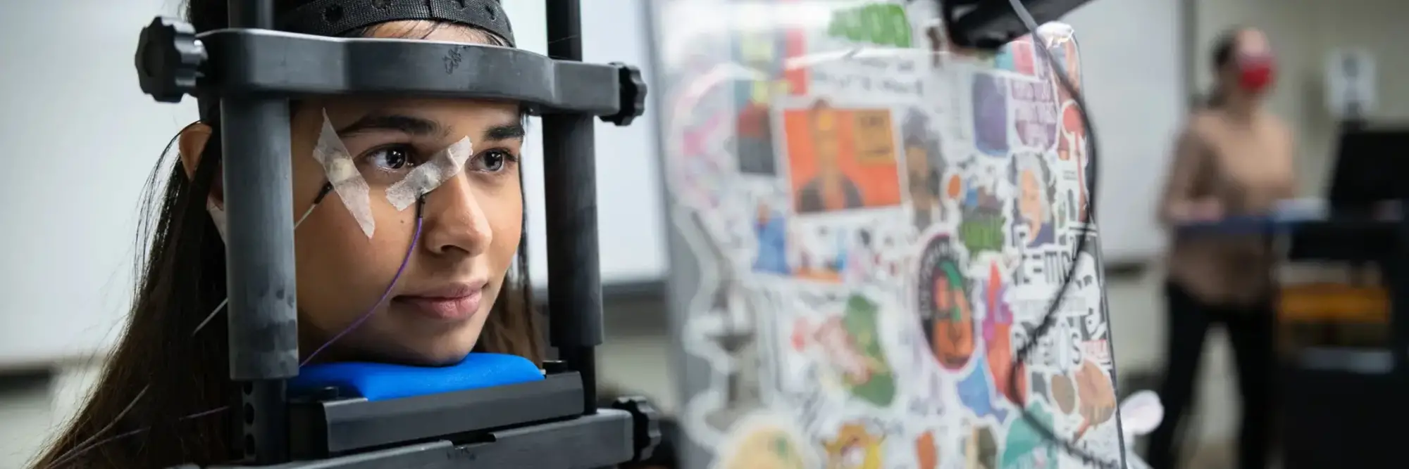 Person using eyetracking technology as they look at a screen.
