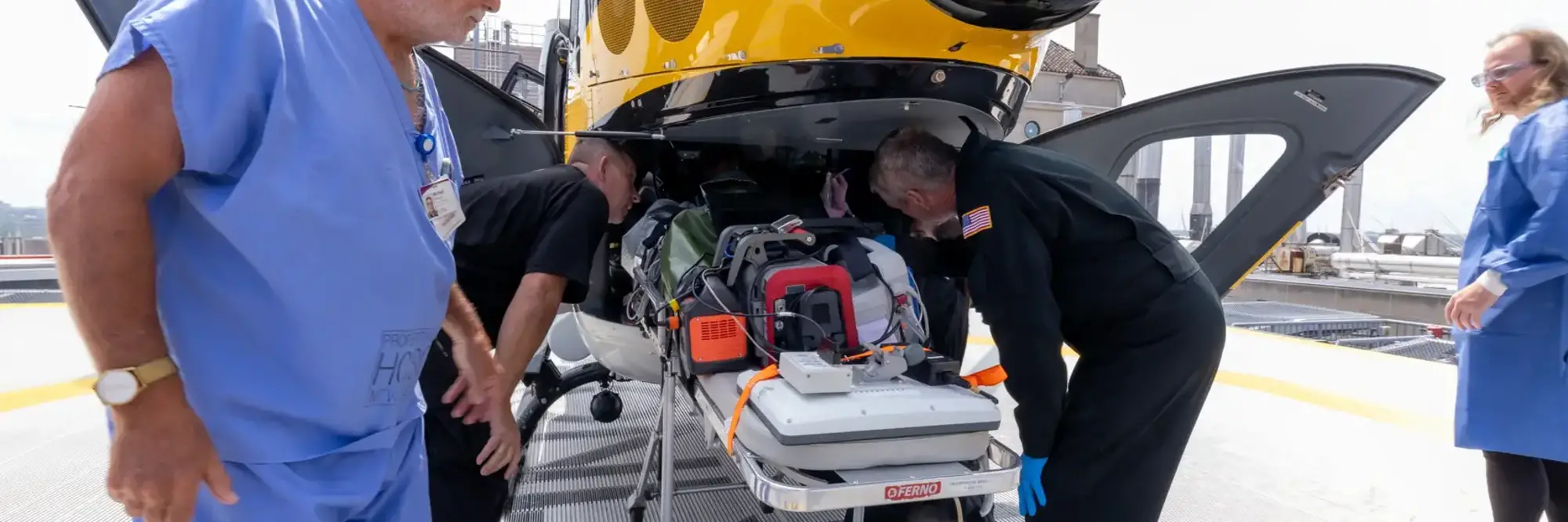 Medical professionals attending to a person on a stretcher.